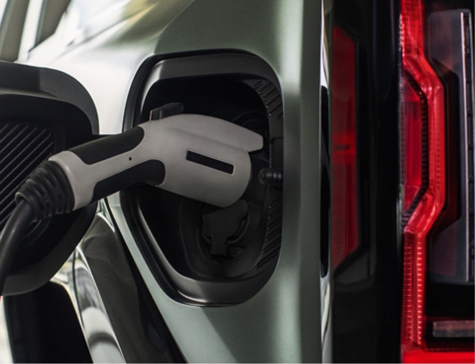 Close up of charging port with charger plugged in on a GMC Hummer EV SUV - Fremont GMC in Riverton WY