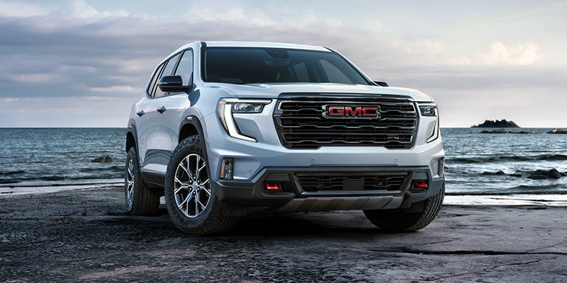 2027 GMC Acadia AT4 with red recovery hooks and 18-inch all-terrain tires