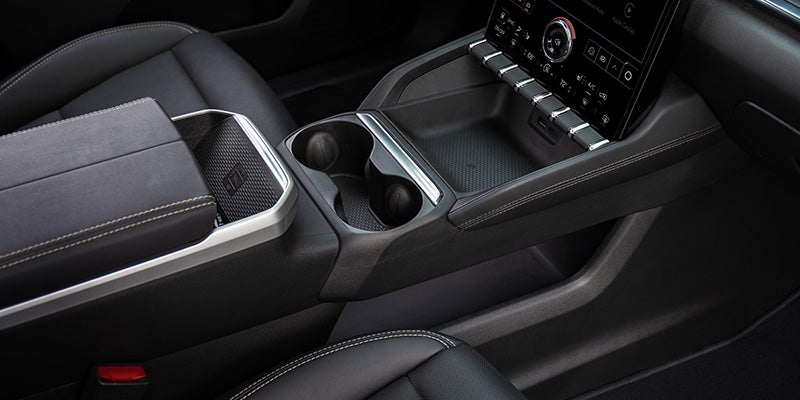 2027 GMC Terrain center console with wireless phone charger and lower pass-through storage